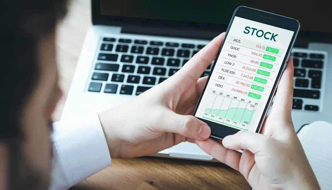 man checking stock options on cell phone
